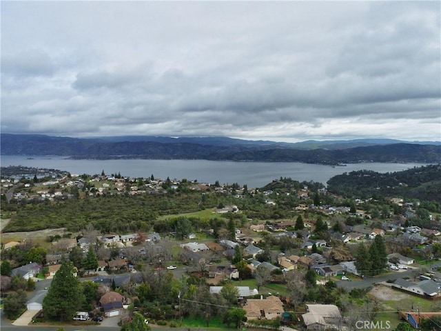 aerial view featuring a water and mountain view