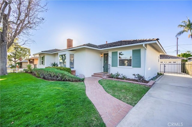 single story home with a chimney, a front yard, and stucco siding