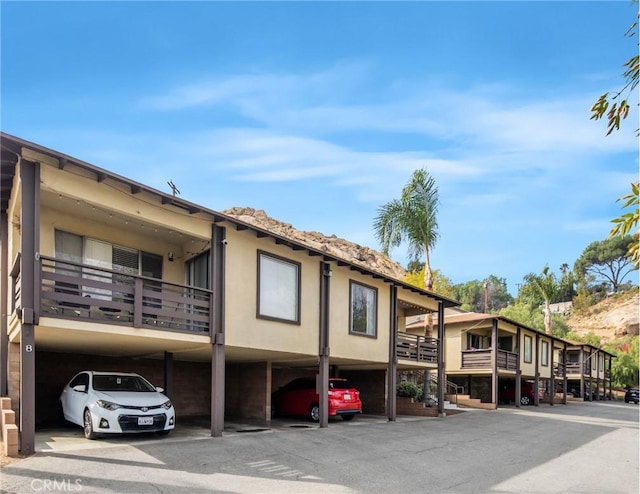 view of property featuring covered parking