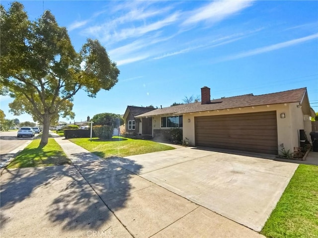 ranch-style house featuring a chimney, stucco siding, an attached garage, a front yard, and driveway