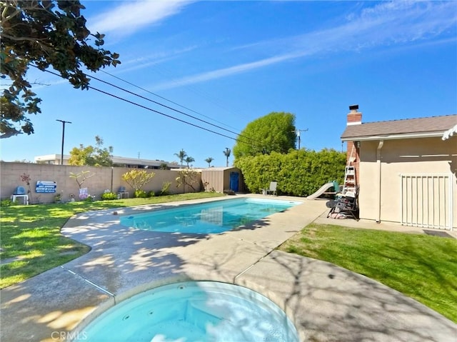 view of pool featuring a storage shed, a fenced in pool, a fenced backyard, an outbuilding, and a patio area