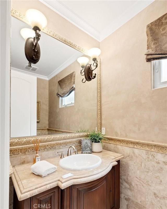 bathroom with crown molding, tile walls, visible vents, wainscoting, and vanity