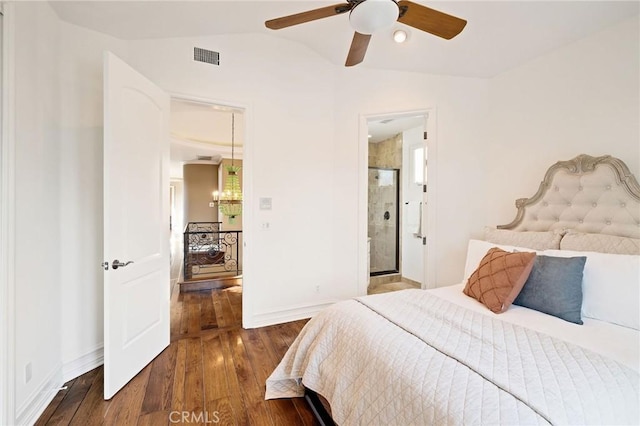 bedroom with baseboards, visible vents, vaulted ceiling, and wood finished floors