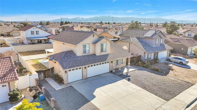 drone / aerial view featuring a residential view and a mountain view