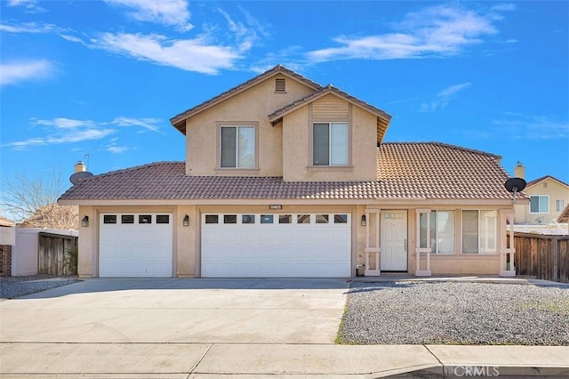 traditional-style home featuring driveway, stucco siding, a tile roof, and fence