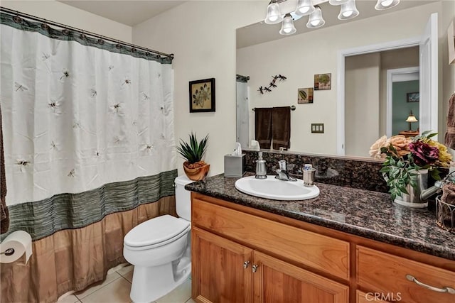 bathroom with curtained shower, vanity, toilet, and tile patterned floors