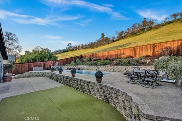 view of patio featuring a fenced in pool and a fenced backyard