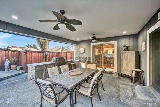 view of patio / terrace featuring outdoor dining space, fence, and a ceiling fan