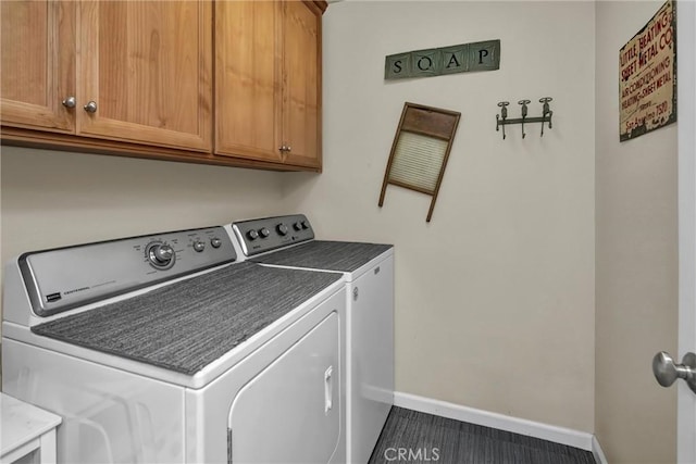 laundry room with washing machine and clothes dryer, cabinet space, and baseboards