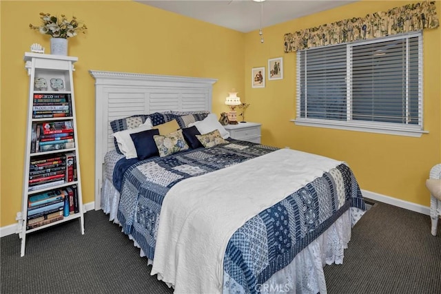 carpeted bedroom featuring baseboards