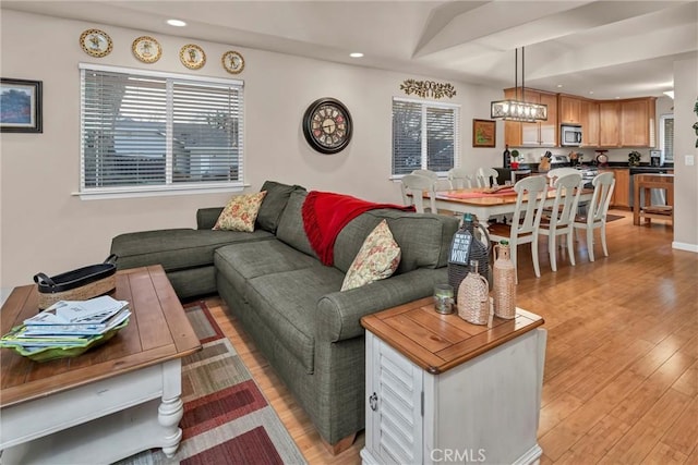 living area with recessed lighting and light wood-style floors