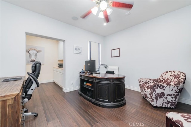 office area with ceiling fan, baseboards, and dark wood finished floors