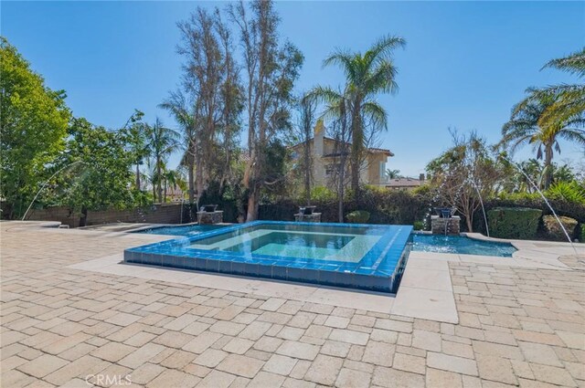 view of swimming pool featuring a patio area