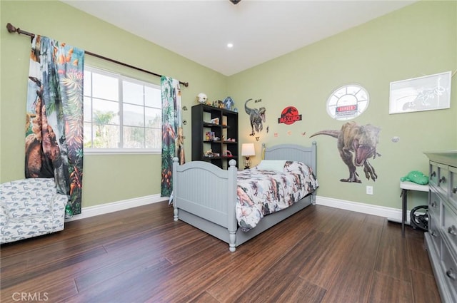 bedroom featuring dark wood-style flooring and baseboards