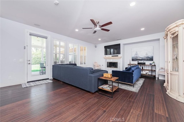 living room with a fireplace, dark wood finished floors, a ceiling fan, and recessed lighting