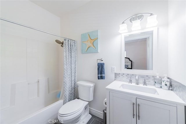 bathroom featuring toilet, shower / bath combo with shower curtain, and vanity