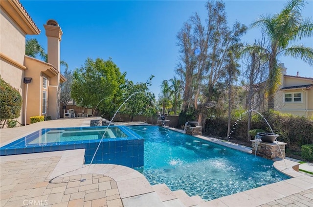 view of swimming pool with fence, a fenced in pool, and an in ground hot tub