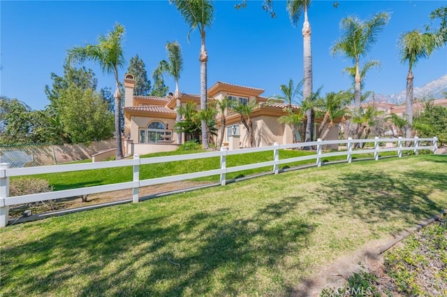 view of yard featuring a fenced front yard and a mountain view