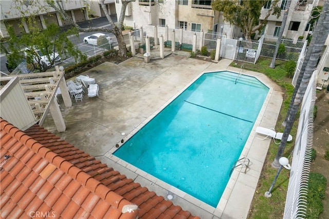 pool featuring a patio area and fence