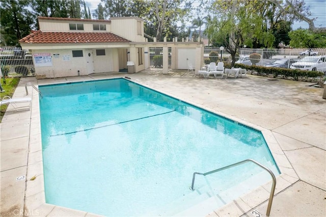 pool featuring a patio and fence