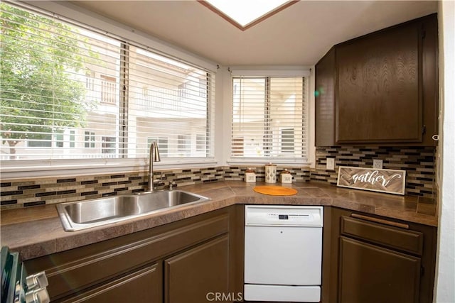 kitchen featuring a sink, tasteful backsplash, dishwasher, and dark brown cabinetry