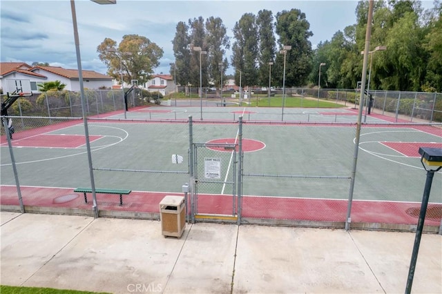 view of sport court with community basketball court, a gate, and fence