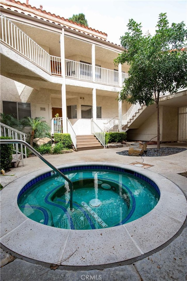 view of swimming pool featuring a community hot tub