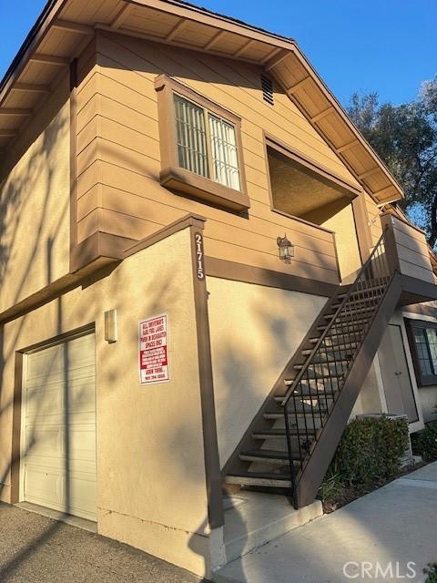 view of home's exterior with a garage and stairway