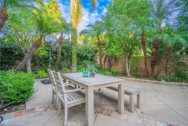 view of patio featuring outdoor dining space and fence