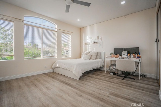 bedroom with recessed lighting, wood finished floors, and baseboards