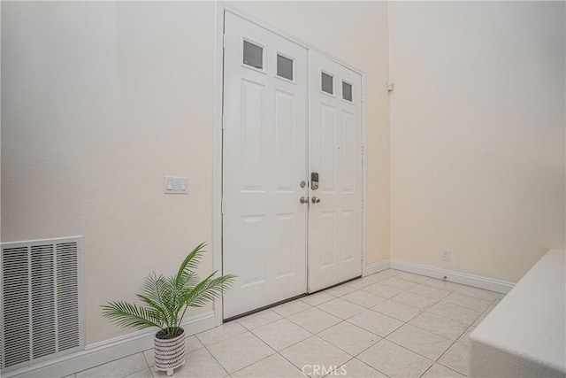 entrance foyer featuring light tile patterned floors, baseboards, and visible vents