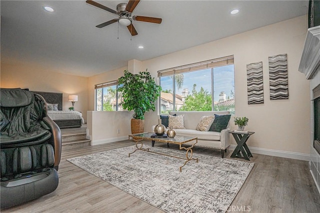 living room with recessed lighting, baseboards, and wood finished floors