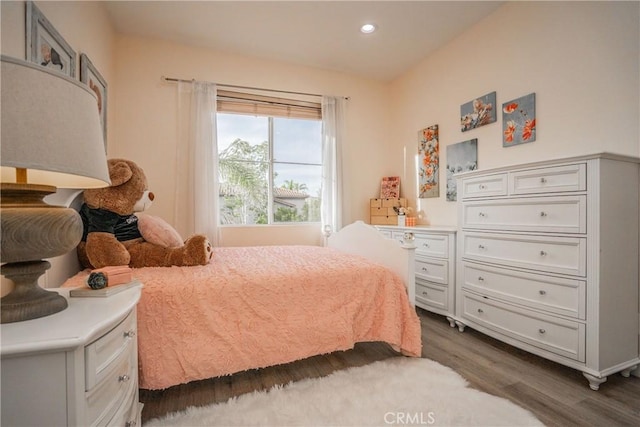 bedroom featuring dark wood-type flooring and recessed lighting