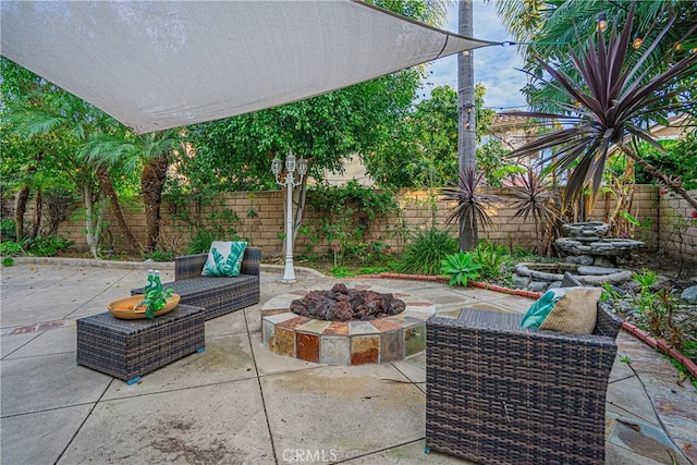 view of patio featuring a fenced backyard and a fire pit