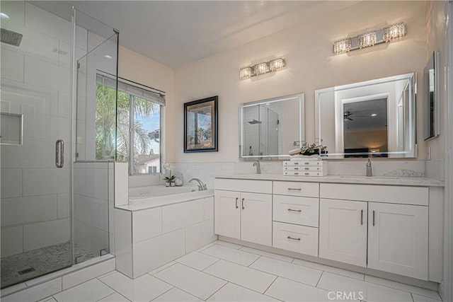 bathroom with a garden tub, a sink, a shower stall, and double vanity