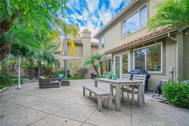 view of patio featuring outdoor dining area and fence