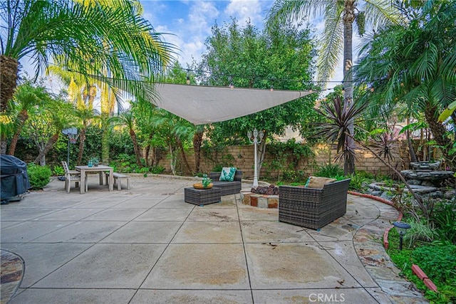 view of patio / terrace featuring a grill, outdoor dining area, and a fenced backyard