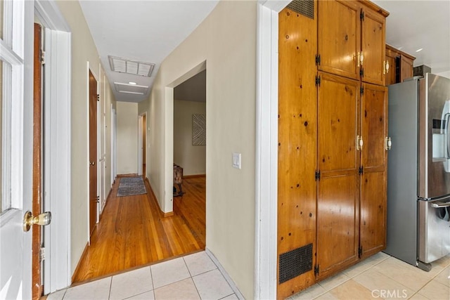 hall with light tile patterned floors and visible vents