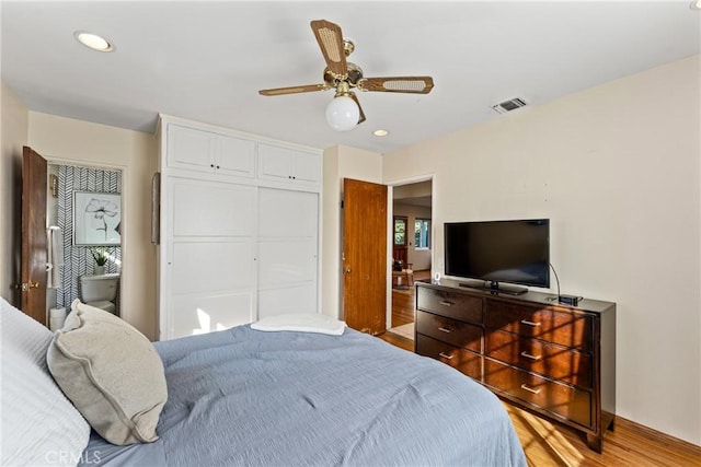 bedroom featuring recessed lighting, a closet, visible vents, a ceiling fan, and wood finished floors