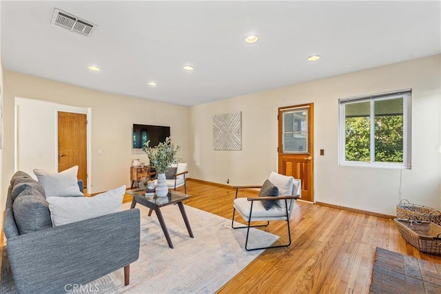 living area with light wood-type flooring, baseboards, visible vents, and recessed lighting