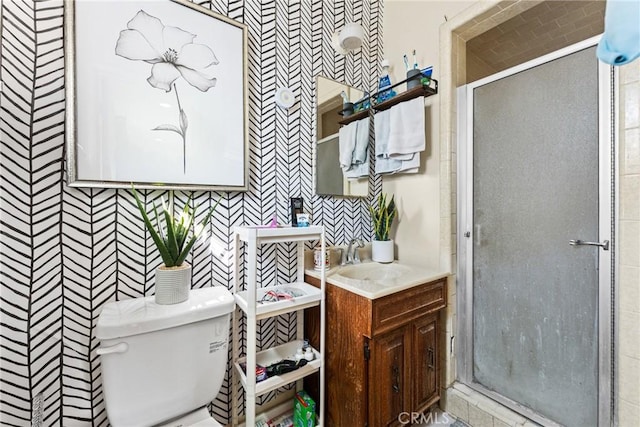 full bathroom featuring toilet, a shower stall, and vanity