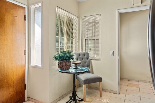 hallway featuring light tile patterned flooring and baseboards