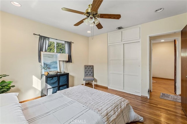 bedroom featuring recessed lighting, a closet, visible vents, and wood finished floors