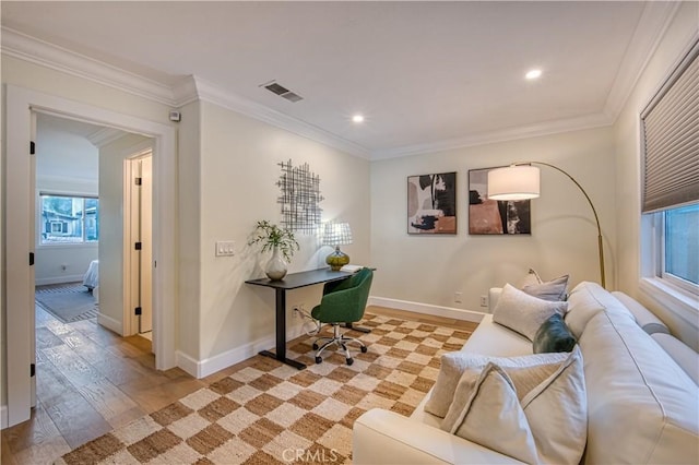 office area with ornamental molding, visible vents, light wood-style flooring, and baseboards