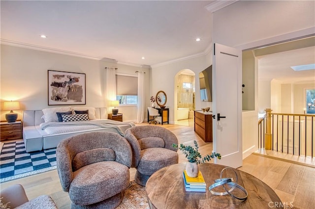 bedroom with arched walkways, recessed lighting, ensuite bathroom, ornamental molding, and light wood-type flooring