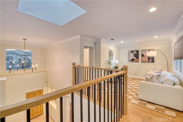 hallway featuring crown molding, recessed lighting, an upstairs landing, a chandelier, and baseboards