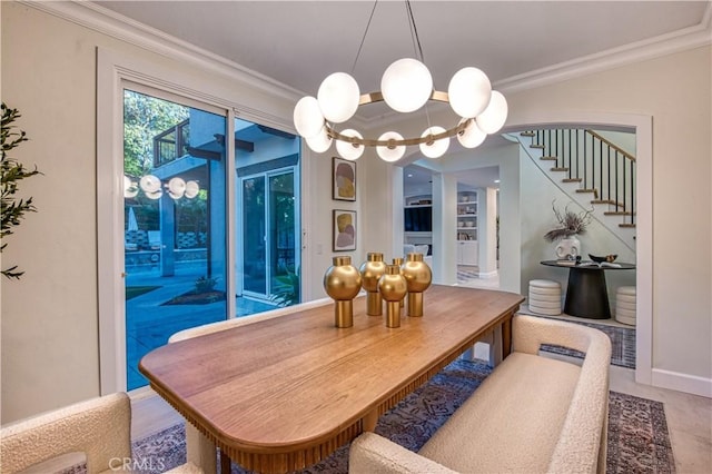 dining room with a notable chandelier, stairs, baseboards, and crown molding