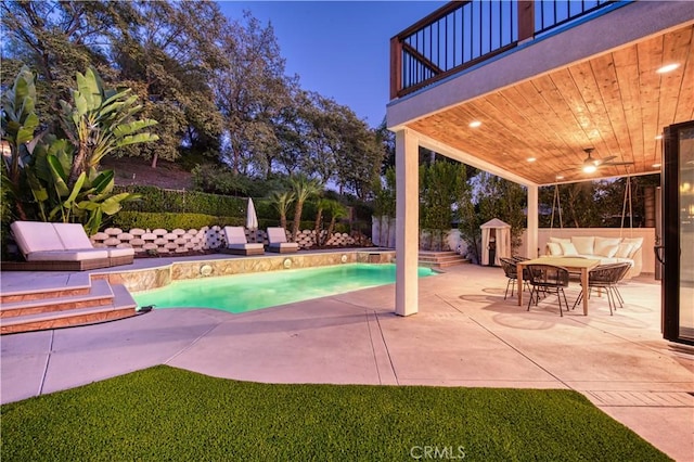 view of swimming pool featuring an outbuilding, a patio, a fenced backyard, and a fenced in pool