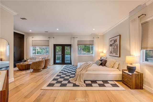 bedroom featuring access to outside, french doors, multiple windows, and wood finished floors