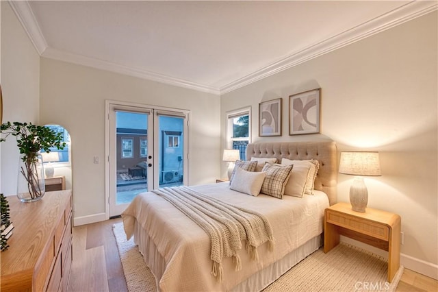 bedroom with access to outside, ornamental molding, french doors, and light wood-style floors